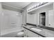 Bright bathroom featuring a bathtub and updated vanity with stone counters at 2901 Ne Lenox Rd # 305, Atlanta, GA 30324