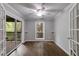 Cozy bedroom featuring hardwood floors, a ceiling fan, and a sliding glass door to the balcony at 2901 Ne Lenox Rd # 305, Atlanta, GA 30324