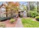 Inviting townhouse featuring manicured lawn, mature trees, and a classic exterior at 2901 Ne Lenox Rd # 305, Atlanta, GA 30324