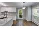 Bright kitchen featuring sleek cabinets, granite countertops, and modern sink with windows at 2901 Ne Lenox Rd # 305, Atlanta, GA 30324