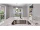 Beautiful kitchen island with granite countertop and modern sink fixtures with natural light at 2901 Ne Lenox Rd # 305, Atlanta, GA 30324