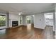 Open-concept living room featuring a fireplace, hardwood floors, and access to the kitchen and balcony at 2901 Ne Lenox Rd # 305, Atlanta, GA 30324