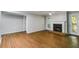 Spacious living room with a cozy fireplace, hardwood floors, and access to outdoor space at 2901 Ne Lenox Rd # 305, Atlanta, GA 30324