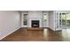 Comfortable living room with fireplace, hardwood floors, and glass doors leading to a balcony at 2901 Ne Lenox Rd # 305, Atlanta, GA 30324