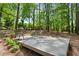 Secluded backyard retreat with a wooden deck, comfortable seating, and lush greenery, perfect for relaxing and enjoying nature at 2029 Dover Hill Ne Pl, Atlanta, GA 30345