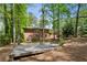 Private backyard featuring a deck, fire pit, and ample seating, perfect for outdoor entertaining and enjoying the natural surroundings at 2029 Dover Hill Ne Pl, Atlanta, GA 30345