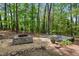 Inviting backyard with a gravel area, fire pit, and comfortable seating on a deck, creating a perfect outdoor gathering spot at 2029 Dover Hill Ne Pl, Atlanta, GA 30345