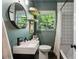 Stylish bathroom featuring a large mirror, natural lighting, and modern fixtures at 2029 Dover Hill Ne Pl, Atlanta, GA 30345
