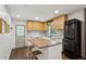 Contemporary kitchen with white cabinets, black appliances, wooden countertops, and stylish breakfast bar at 2029 Dover Hill Ne Pl, Atlanta, GA 30345