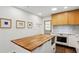 Modern kitchen boasting custom cabinetry, a wood-top island, stainless steel appliances and white subway tile at 2029 Dover Hill Ne Pl, Atlanta, GA 30345