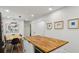 This kitchen features modern lighting, a wooden countertop island, and sleek white walls at 2029 Dover Hill Ne Pl, Atlanta, GA 30345