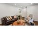 Bright living room featuring a brown leather sofa, a comfortable rocking chair, and hardwood floors at 2029 Dover Hill Ne Pl, Atlanta, GA 30345