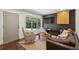 Cozy living room with large windows, modern furniture, and a stylish black accent wall with custom shelving at 2029 Dover Hill Ne Pl, Atlanta, GA 30345
