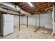 Unfinished basement providing ample storage space, a refrigerator, and potential for customization and future expansion at 2029 Dover Hill Ne Pl, Atlanta, GA 30345