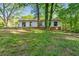 Backyard view of home with patio and beautiful green grass at 2254 Lisbon Ln, Jonesboro, GA 30236