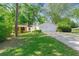 Charming home with a brick facade, white garage, and lush green lawn at 2254 Lisbon Ln, Jonesboro, GA 30236