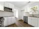 Modern kitchen with stainless steel appliances, white cabinets, and granite countertops at 2254 Lisbon Ln, Jonesboro, GA 30236
