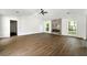 Spacious living room with modern fireplace, ceiling fan, and hardwood floors at 2254 Lisbon Ln, Jonesboro, GA 30236