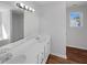 Bathroom featuring double sinks, a large mirror and laminate floors at 4269 David Austin Ct, Snellville, GA 30039