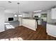 Bright kitchen with white cabinets, stainless steel appliances and an open view to the fireplace in the living room at 4269 David Austin Ct, Snellville, GA 30039