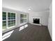Spacious living room featuring a fireplace, large windows, and plush carpeting at 4269 David Austin Ct, Snellville, GA 30039