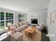 Bright living room with large windows, fireplace, and neutral decor, perfect for relaxation at 4269 David Austin Ct, Snellville, GA 30039
