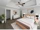 Serene main bedroom with a tray ceiling, ceiling fan, and neutral color scheme at 4269 David Austin Ct, Snellville, GA 30039