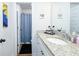 Bright bathroom with granite countertops, a modern sink, and blue patterned shower curtain at 475 Mcdonough Rd, Fayetteville, GA 30214
