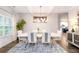 Elegant dining area featuring a large table, chandelier, and wainscoting, ideal for Gathering meals at 475 Mcdonough Rd, Fayetteville, GA 30214