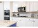 This well-appointed kitchen has stainless steel appliances, granite countertops, and ample storage for the inspired home chef at 475 Mcdonough Rd, Fayetteville, GA 30214