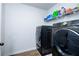 Modern laundry room with stainless steel washer and dryer, and wire shelving at 475 Mcdonough Rd, Fayetteville, GA 30214