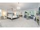 Spacious main bedroom suite with four poster bed, decorative fireplace, and sitting area at 475 Mcdonough Rd, Fayetteville, GA 30214