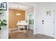 An elegant entry leading to a room featuring a white piano, a chandelier, and striking wall accents at 475 Mcdonough Rd, Fayetteville, GA 30214