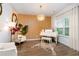 A bright room with a white piano, stylish accents, and natural light from the window, creating an artistic ambiance at 475 Mcdonough Rd, Fayetteville, GA 30214