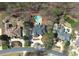 An aerial view shows an in-ground pool, surrounded by mature trees, with a gray roofed home at 621 Champions Dr, Mcdonough, GA 30253