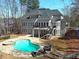 Enjoy the outdoors in this amazing backyard with a sparkling pool, spa, and comfortable seating area at 621 Champions Dr, Mcdonough, GA 30253
