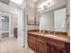 Bathroom features double sinks, granite countertops, and dark wood cabinetry at 621 Champions Dr, Mcdonough, GA 30253