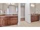 Bathroom with a double vanity, dark wood cabinets and a tile floor at 621 Champions Dr, Mcdonough, GA 30253