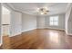 Large, empty bedroom with hardwood floors, a ceiling fan, and a single window with blinds at 621 Champions Dr, Mcdonough, GA 30253