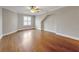 A bright bedroom featuring hardwood floors, a ceiling fan, and a large window with plenty of light at 621 Champions Dr, Mcdonough, GA 30253