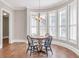 Charming dining area with natural light from bay windows, featuring seating for four and hardwood floors at 621 Champions Dr, Mcdonough, GA 30253