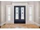 Elegant front entrance with intricate wrought iron double doors and sidelight windows at 621 Champions Dr, Mcdonough, GA 30253