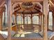 A wooden gazebo with wooden swing and benches sits in a wooded backyard at 621 Champions Dr, Mcdonough, GA 30253