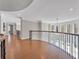 Long hallway features hardwood flooring and wrought-iron railings overlooking the great room below at 621 Champions Dr, Mcdonough, GA 30253