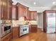 Gourmet kitchen featuring professional-grade stainless steel appliances and custom wood cabinetry at 621 Champions Dr, Mcdonough, GA 30253