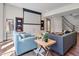 A living room with comfortable seating, a ceiling projector screen, and built-in bookshelves for an immersive experience at 621 Champions Dr, Mcdonough, GA 30253