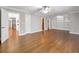 An open-concept living room with hardwood floors and built-in bookshelves, bathed in natural light at 621 Champions Dr, Mcdonough, GA 30253