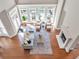 Aerial view of living room with a fireplace, large windows and outdoor seating at 621 Champions Dr, Mcdonough, GA 30253