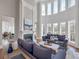 Open-concept living room with a fireplace and large windows at 621 Champions Dr, Mcdonough, GA 30253