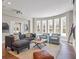 Bright living room boasts many windows, neutral furniture, and a light rug at 621 Champions Dr, Mcdonough, GA 30253